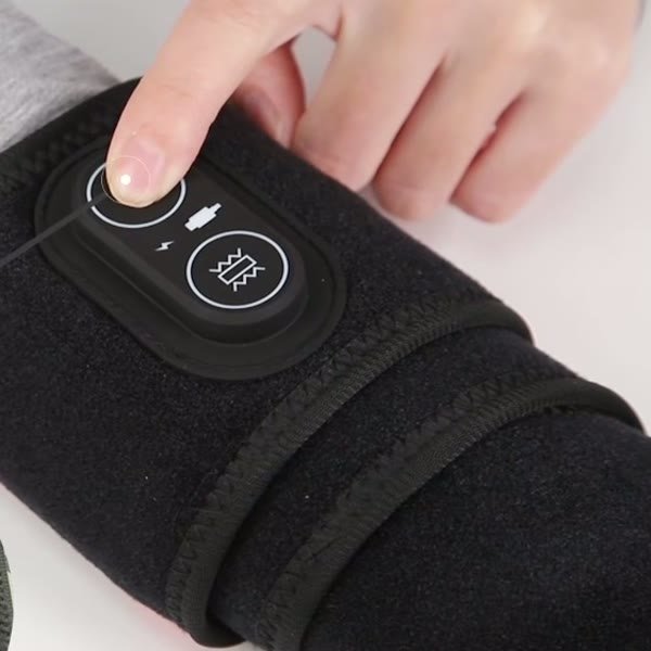 A finger pressing the power button on the wrap's controller